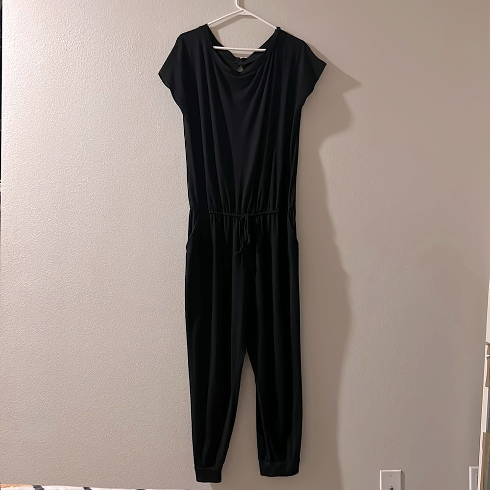 Minimal sleeveless black drawstring jumpsuit with pockets